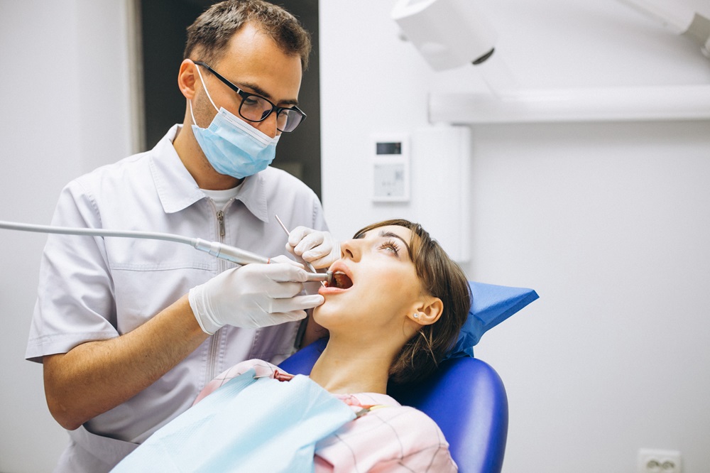 dentist performing dental cleaning treatment